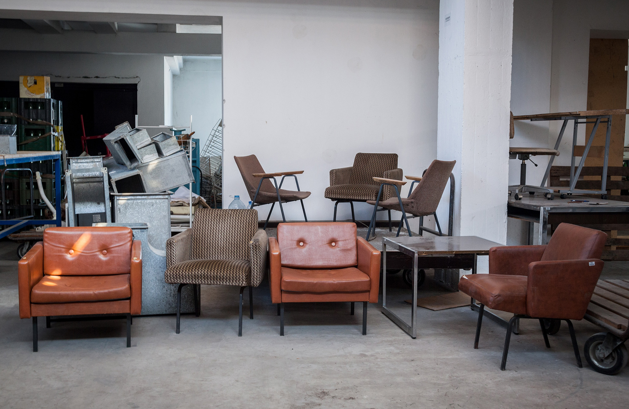 storage unit with old armchairs stored in it