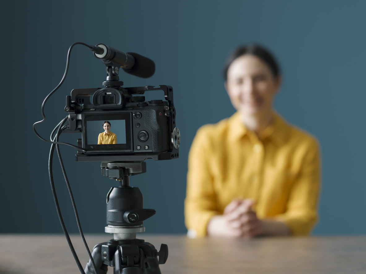 Professional vlogger sitting in front of a camera