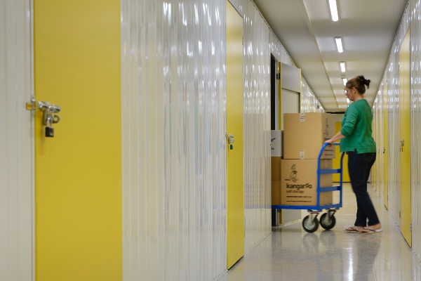 Someone wheeling items into a storage unit