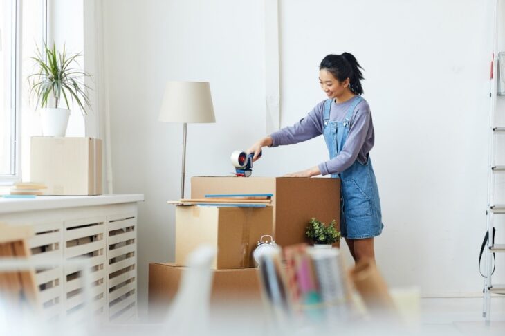 Student boxing up belongings from university flat